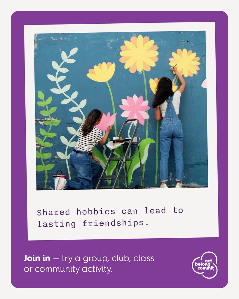Two people painting a colourful flower mural together, with the message “Shared hobbies can lead to lasting friendships” and an invitation to join a community activity.